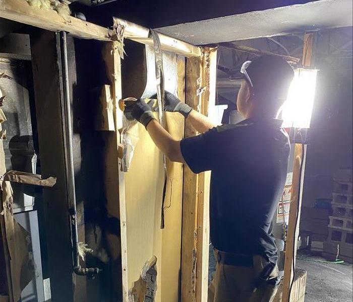 SERVPRO Technician removing materials in fire damaged home 